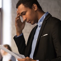 Man looking worried holding paper
